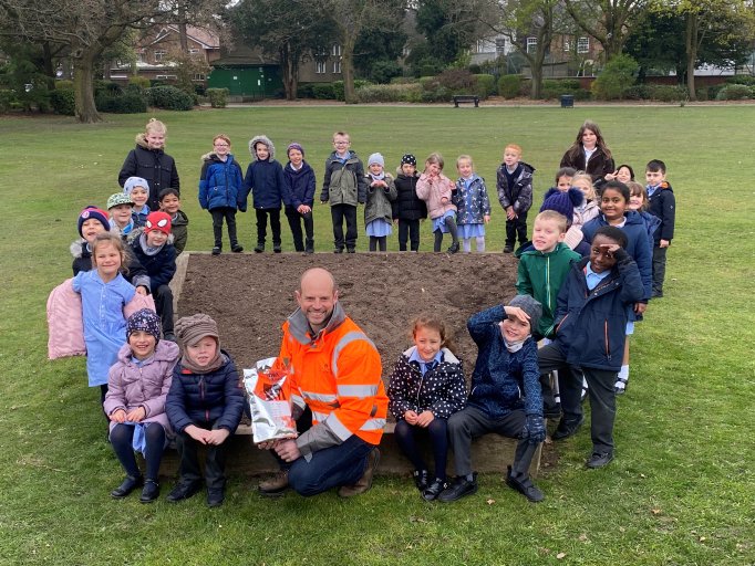 A photo of pupils from Coalville schools, St Clare's Primary School and Belvoirdale Primary School taking part in North West Leicestershire District Council's wildflower planting project.