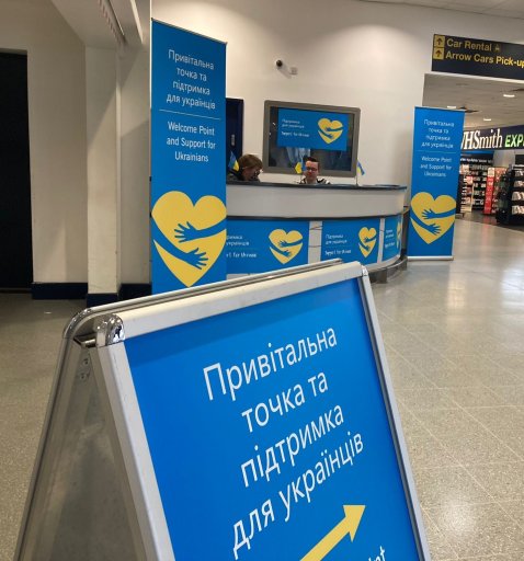 Welcome desk with Ukrainian colours at East Midlands Airport