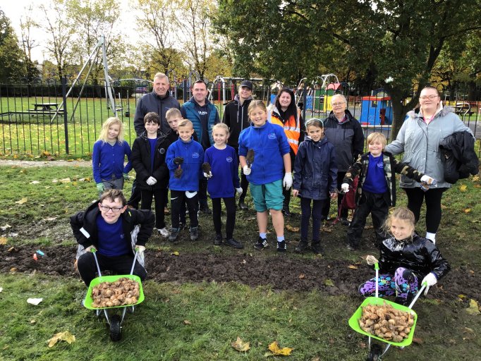 Pupils from Hugglescote Primary School plant spring bulbs in Coalville Park