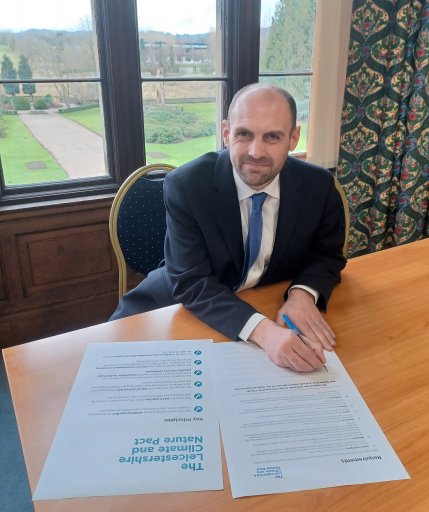 Cllr Andrew Woodman signs the Leicestershire County Council Climate and Nature Pact in 2023