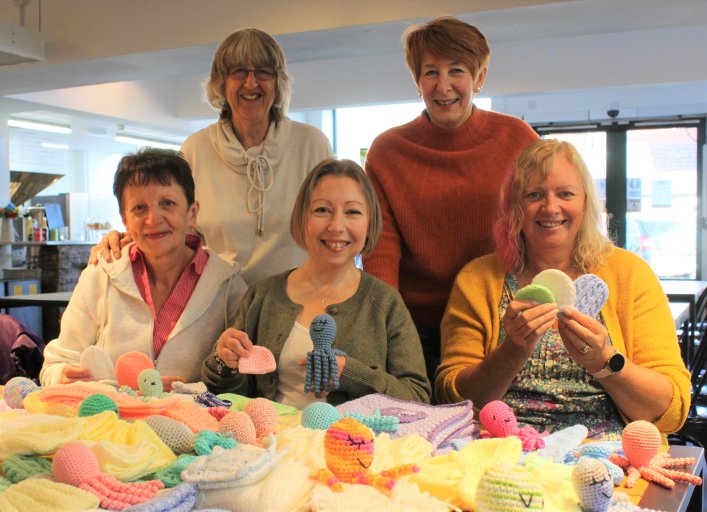 Members from the Knit and Natter group at Newmarket with their donations for Cosy Clothes for Tiny Miracles.