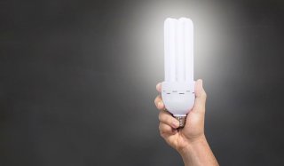 Hand holding an energy saving lightbulb