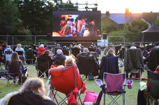 Residents and visitors enjoying the Cinema in the Park event at Coalville Park