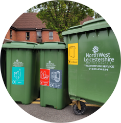 Three green commercial recycling bins